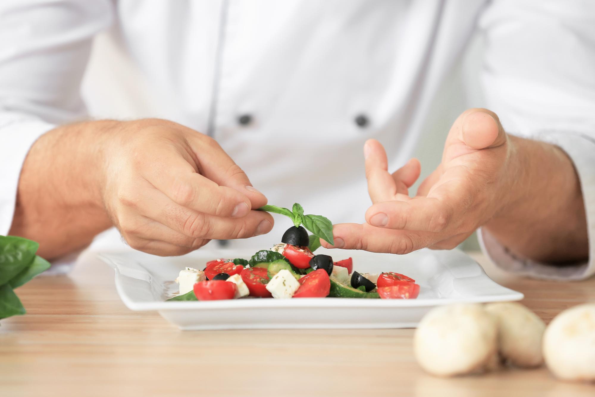 Chef preparing local dish in a bright kitchen